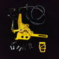 Gold Sur-Ron Light Bee foot-brake pedal assembly with master cylinder, hose, toe peg and hardware laid out for install
