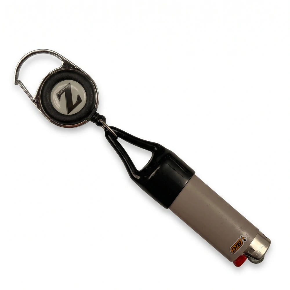 FactoryZ Lighter Leash holding a BIC-style lighter in the black silicone boot, retractable reel and metal clip