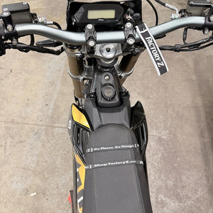 FactoryZ Phone Band installed on a Surron seat, two black bands across the seat, top view from the handlebars