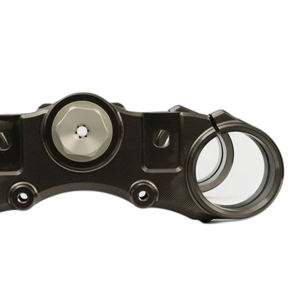 Top crown of the Pure Racing Traxion triple clamp showing the stem nut and bar clamp bores