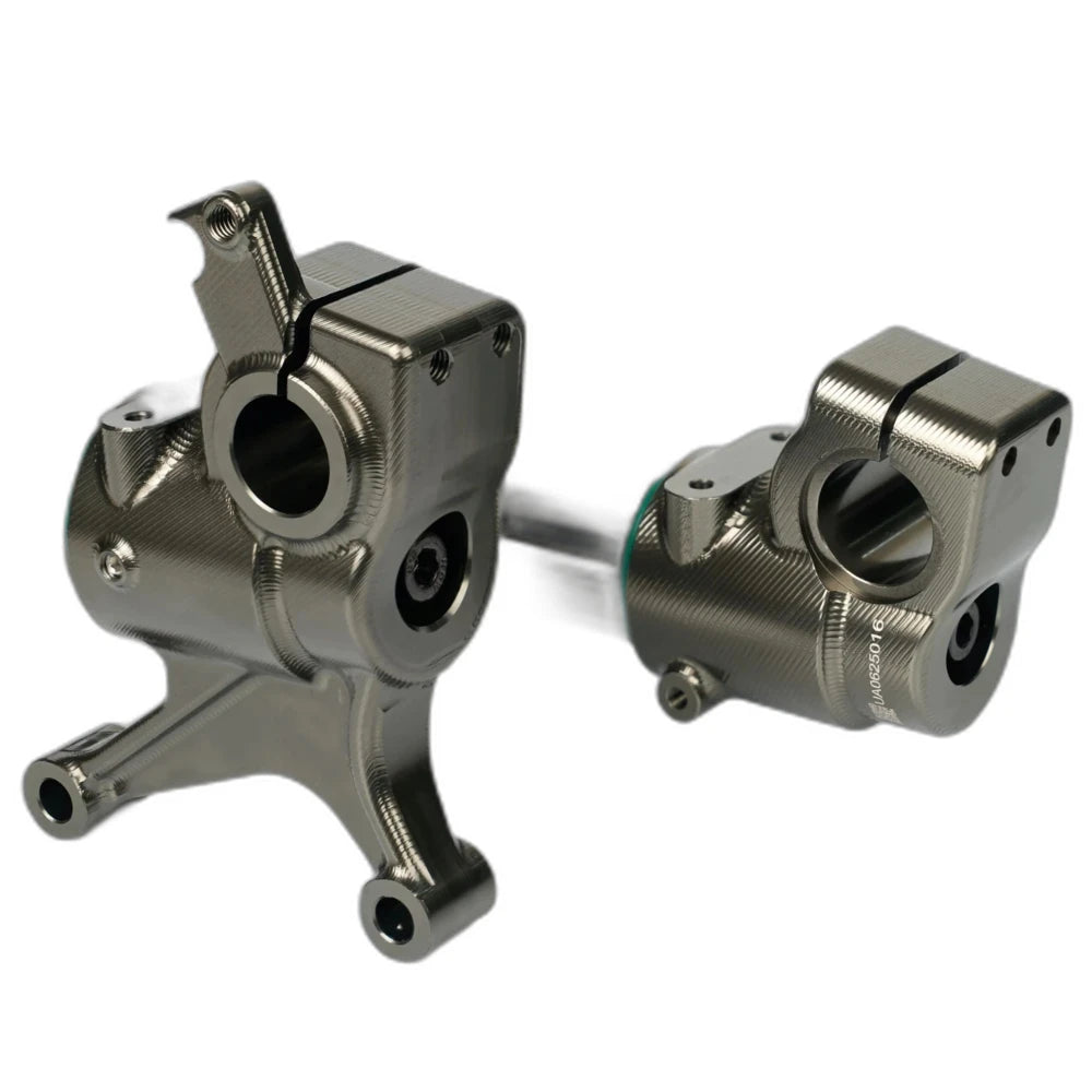 CNC machined dropouts and axle hardware on the Pure Traxion fork for Surron Ultra Bee
