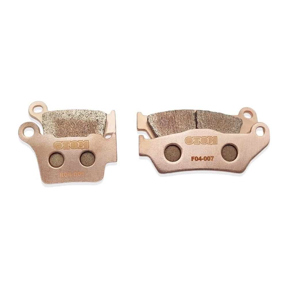 Stark Varg brake pads, front F04-007 and rear R04-009 sets side by side, copper-colored backing plates facing out