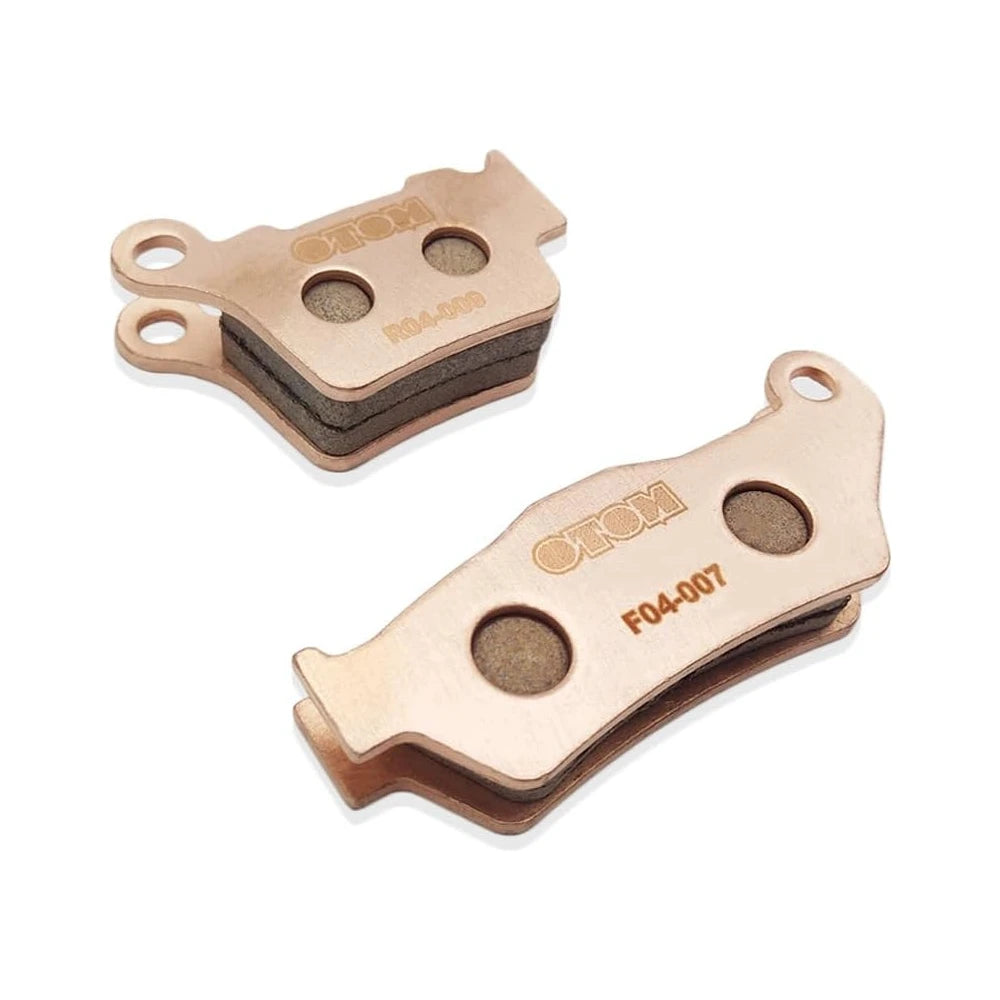 Stark Varg brake pads, raised angled view of the rear R04-009 and front F04-007 sets with the friction layers visible