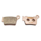 Stark Varg brake pads, rear R04-009 set laid flat, one pad showing its friction face and one showing the backing plate