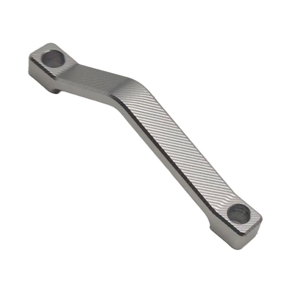 Silver 220mm Surron brake caliper adapter bracket spacer, angled view