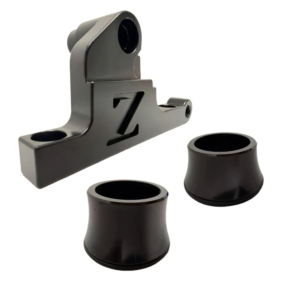 Surron front moto brake caliper mounting bracket, black anodized CNC billet with FactoryZ Z logo, plus two wheel spacers
