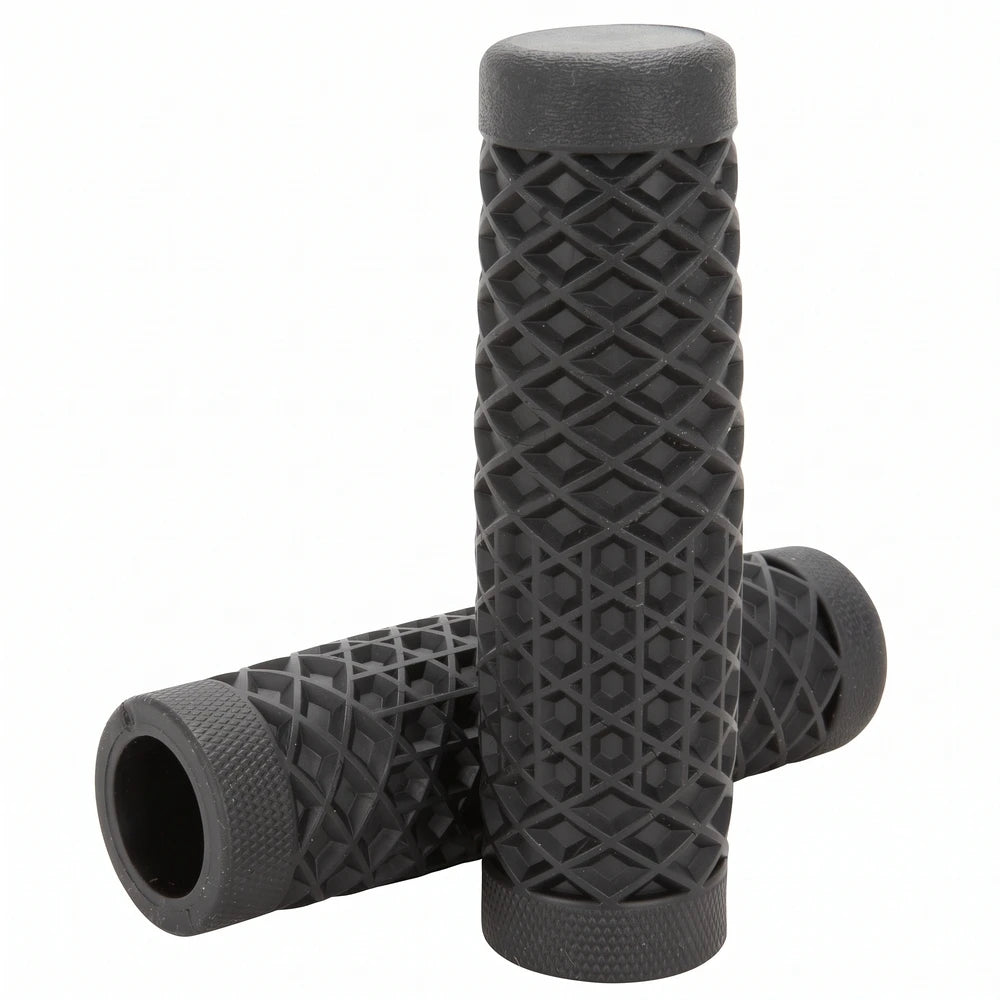 Surron grips in black waffle pattern, one grip standing on the other to show the open bore and knurled ends