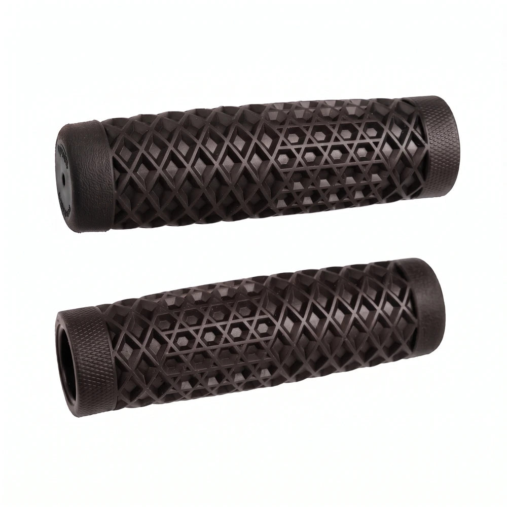Surron waffle grips in black, pair laid side by side showing the diamond and hex pattern