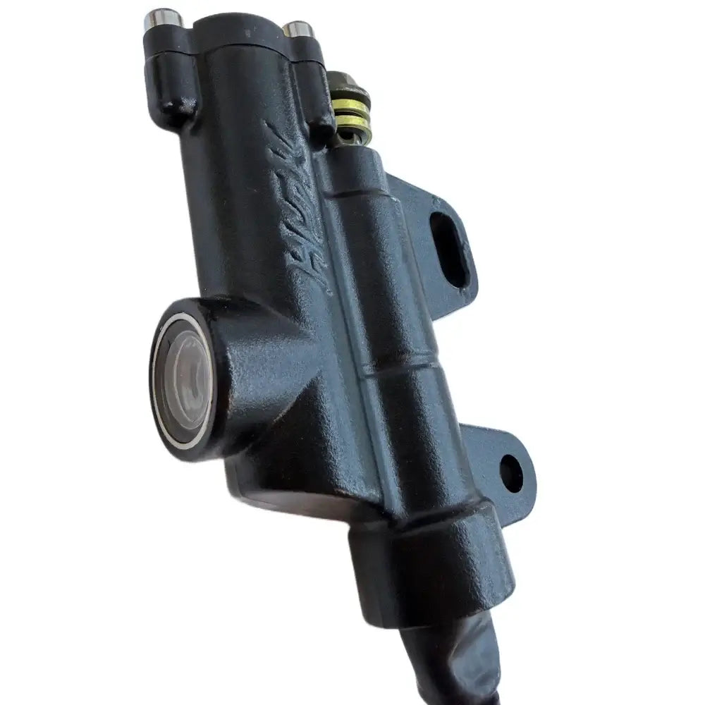 Surron Light Bee HSK foot brake master cylinder, black cast finish, side view showing piston bore and mounting tabs