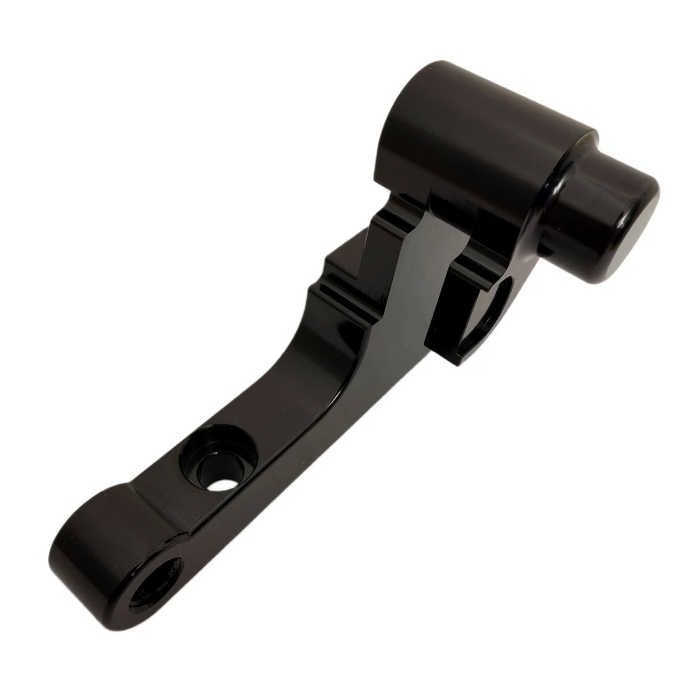 Surron front moto brake caliper bracket, black anodized CNC-machined aluminum, twin mounting bolt holes, angled back view