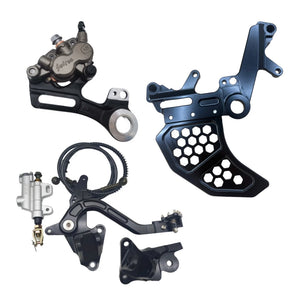 Complete Surron Ultra Bee foot brake kit with dual caliper bracket, master cylinder, and brake pedal in black