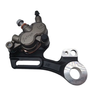 Surron Ultra Bee OEM rear brake caliper, front three-quarter view showing Surron branding, bleed nipple, and black aluminum mounting bracket