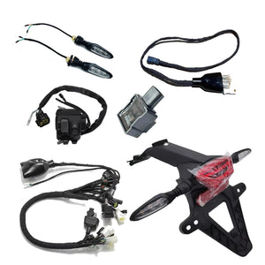 Complete Surron Ultra Bee street legal kit including tail light bracket, turn signals, wiring harnesses, switch, and flasher relay
