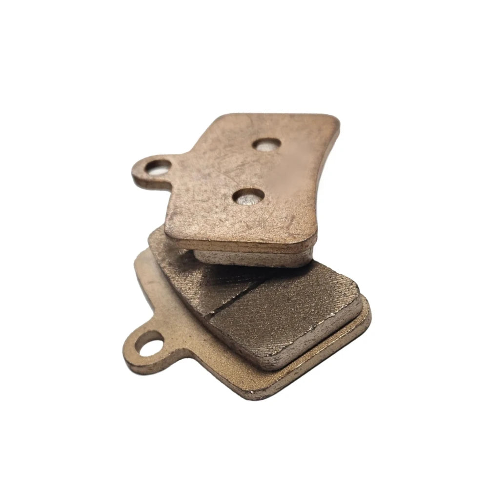 Rear plate detail of Talaria MX5 copper sintered brake pads showing twin locator holes for easy installation.