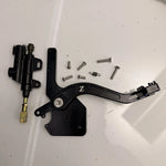 Tuttio foot brake kit contents: lever, bracket, master cylinder, return spring, and bolts
