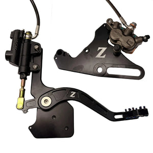 Tuttio Soleil 01 foot brake kit, wide black caliper bracket, OEM Surron Ultra Bee caliper and steel-braided line