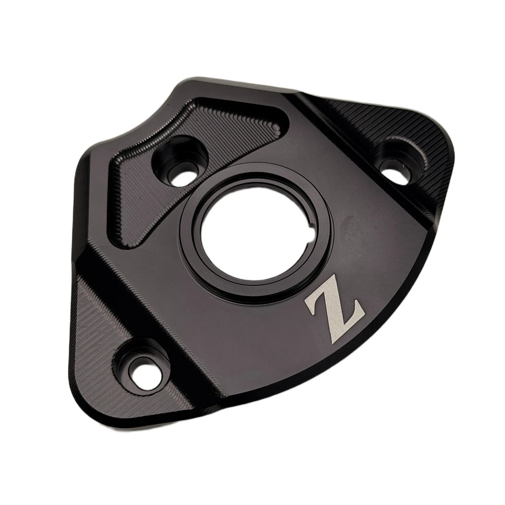 Yozma IN 10 ignition cover in black aluminum, angled view of the machined key ring and three bolt holes